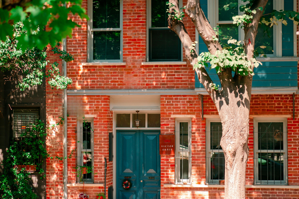 Townhome front of house with trees pictured