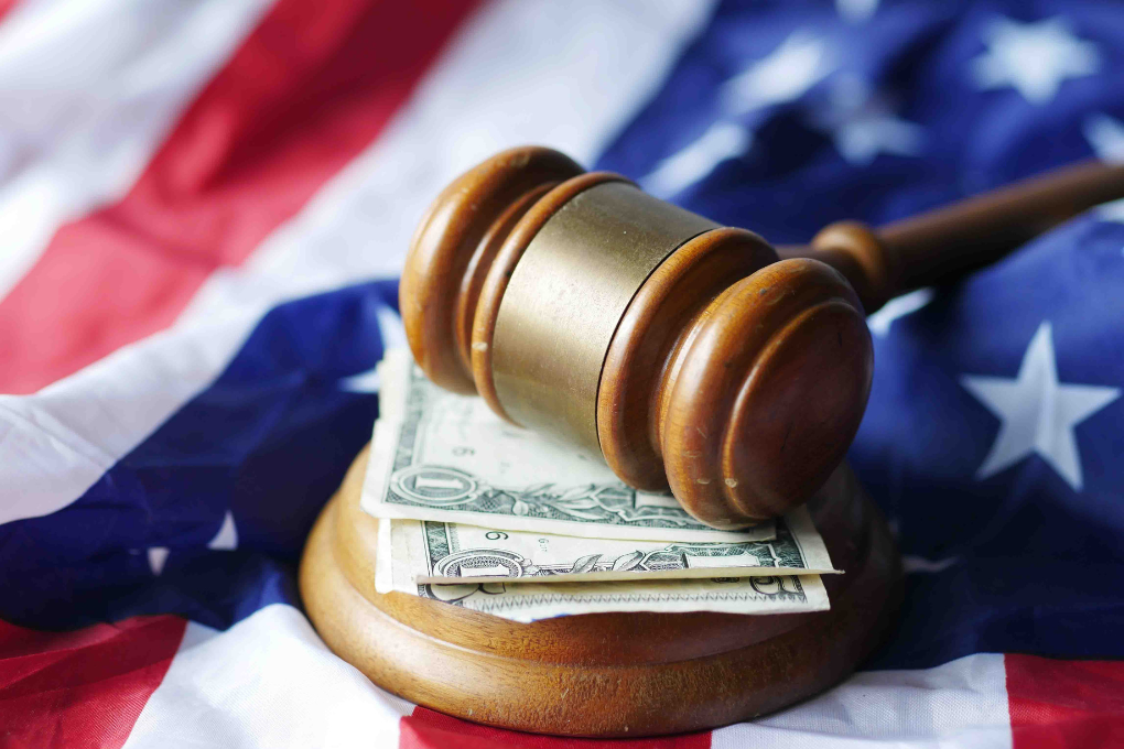 Gavel with money, United States flag.