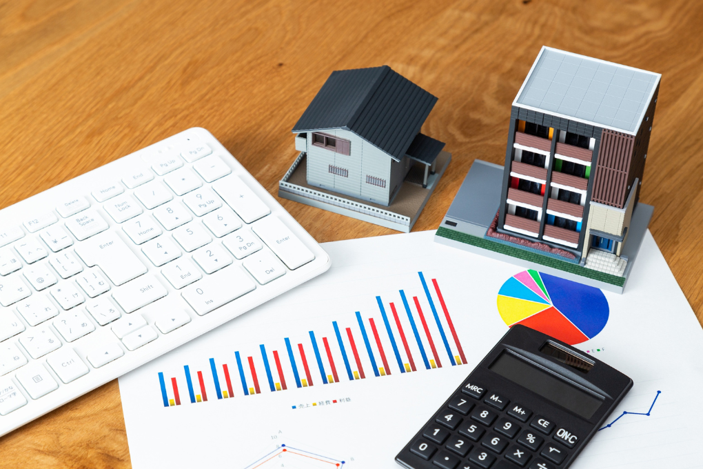 Table with calculator, report, small house, etc.