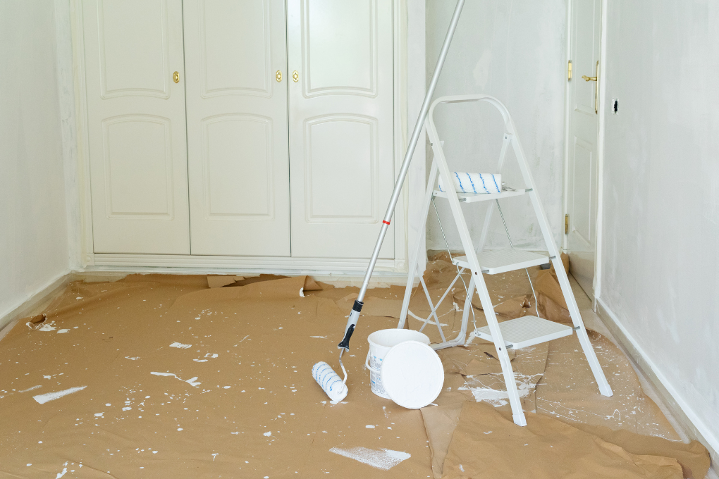 Home renovation. Painting supplies in an empty room.