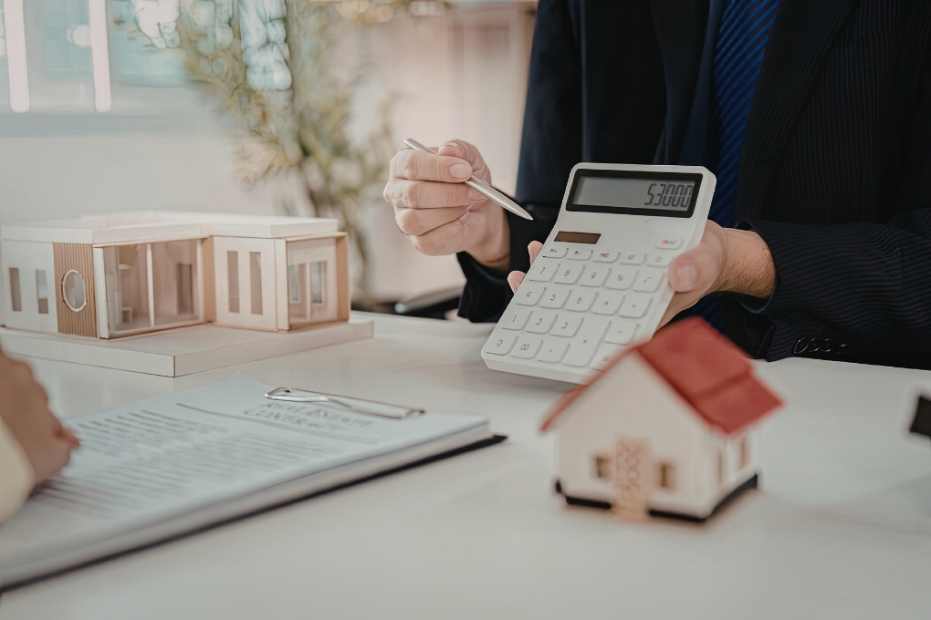 Real estate investor underwriting a deal with a calculator on the desk.