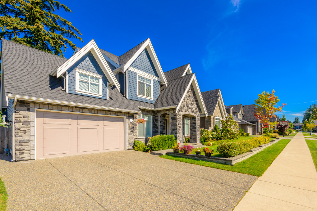 Street view of a house on a sunny day.